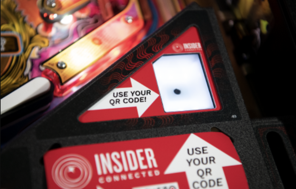 Player scanning the Stern Insider Connected QR code on a pinball machine
